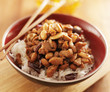 bowl of kung pao chicken with chopsticks