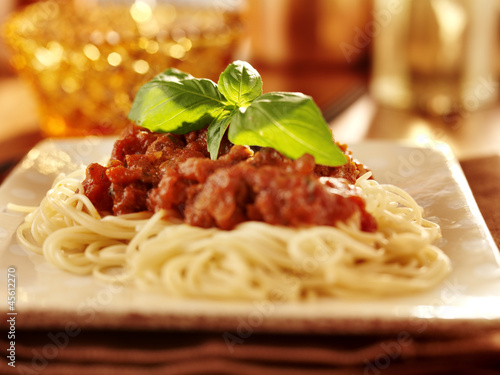 Photo: Spaghetti with basil garnish and tomato sauce. Spaghetti with basil garnish and tomato sauce.