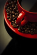 red coffee cup and grain on black