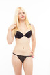 Sexy blonde woman in black lingerie on white isolated