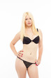 Sexy blonde woman in black lingerie on white isolated