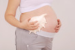 Pregnant woman has put a seashell to his stomach