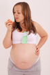 Pregnant woman eating an apple.