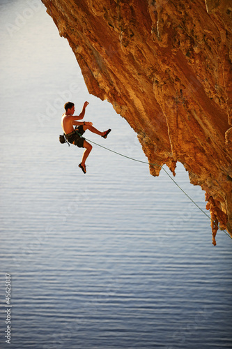 Photo: Rock climber falling of a cliff while lead climbing Rock climber falling of a cliff while lead climbing