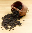 Coffee seeds spread from the wooden basket on the table