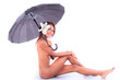 Beautiful naked body of young woman with umbrella