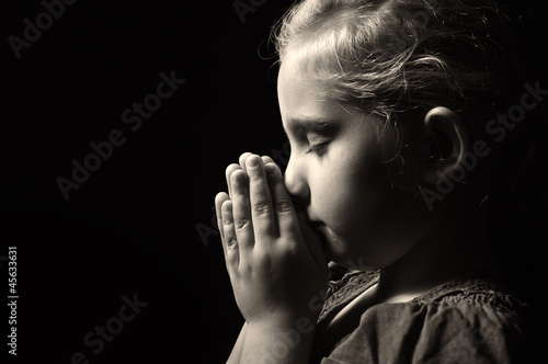 Photo: Praying child. Praying child.