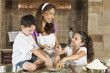 Attractive Family Baking and Eating Cookies In A Kitchen