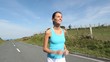 Young woman running on the road
