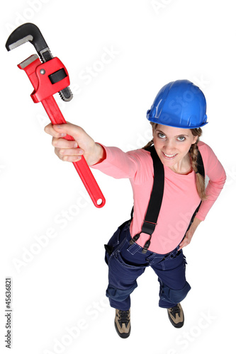Photo: Female plulmber holding wrench Female plulmber holding wrench