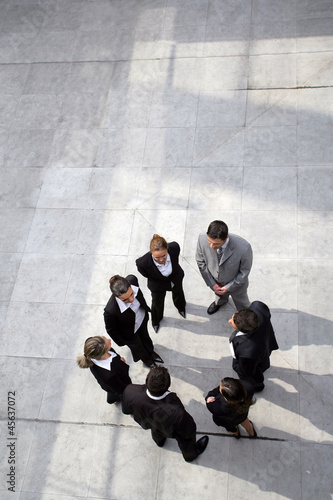 Photo: Business team stood in a circle Business team stood in a circle