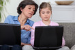 Girl with her grandmother and laptop computers