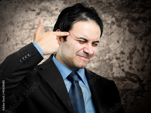 Photo: Businessman shooting himself Businessman shooting himself