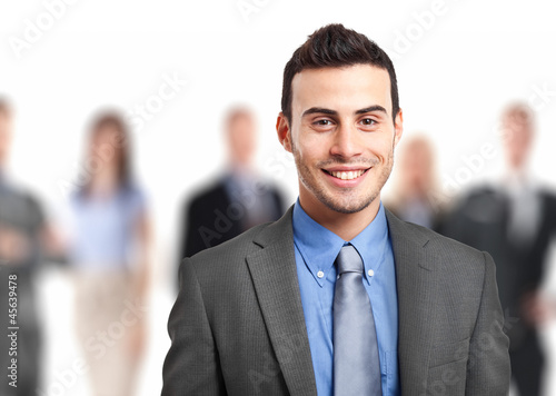 Photo: Smiling businessman with his team Smiling businessman with his team