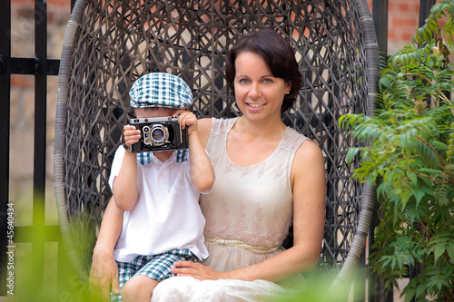 Photo: Mother and her little son with retro camera Mother and her little son with retro camera