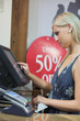 Woman is standing behind the counter while typing