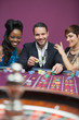 Man playing roulette with two women