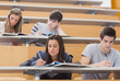 Photo: Students sitting at desks in lecture hall Students sitting at desks in lecture hall