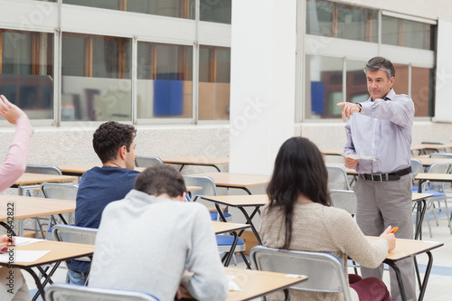 Photo: Teacher pointing at student asking question Teacher pointing at student asking question