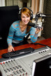 Female dj working in front of a microphone on the radio