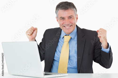 Photo: Succesful man sitting at his desk with laptop Succesful man sitting at his desk with laptop