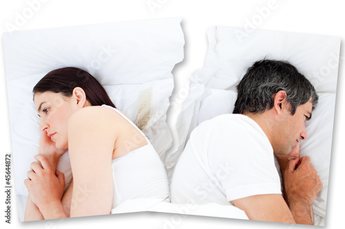 Photo: Couple turned away from each other in bed Couple turned away from each other in bed