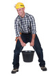 craftsman carrying a very heavy bucket