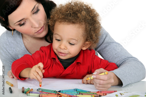 Photo: Mother sat with boy drawing Mother sat with boy drawing