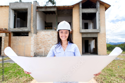 Photo: Woman looking at a house project Woman looking at a house project