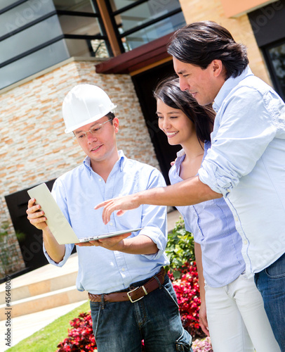 Photo: Architect showing house to a couple Architect showing house to a couple
