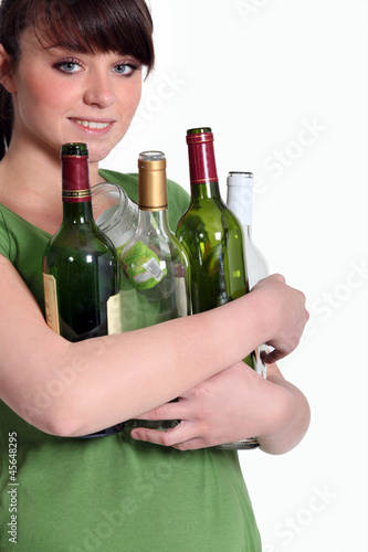 Photo: Girl recycling glass bottle Girl recycling glass bottle