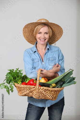 Photo: Woman with a vegetable basket Woman with a vegetable basket