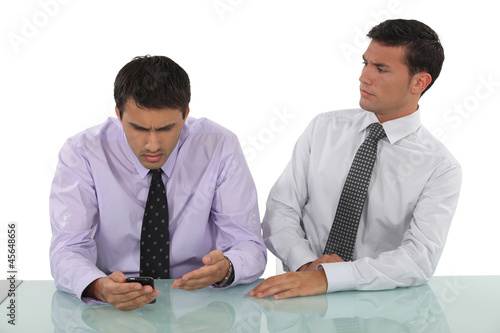 Photo: Expressive businessmen sitting at a desk Expressive businessmen sitting at a desk