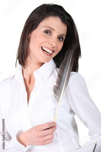 Photo: Woman holding a feather Woman holding a feather