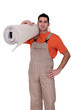 craftsman holding a carpet