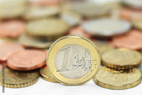 Photo: Euro coins. One Euro coin on the foreground. Shallow DOF Euro coins. One Euro coin on the foreground. Shallow DOF