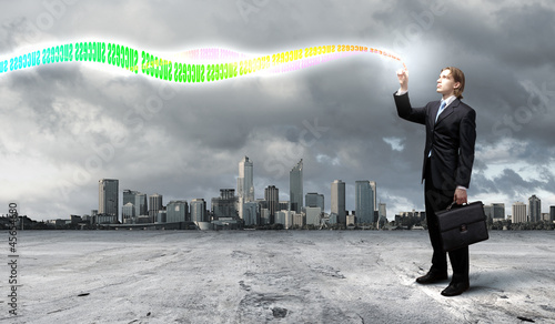 Photo: Businessman with colourful light beam in his hands Businessman with colourful light beam in his hands