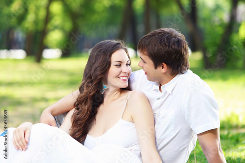 Photo: Young love Couple smiling under blue sky Young love Couple smiling under blue sky