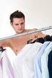 The young man chooses a shirt