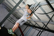 Young gymnast training on rings