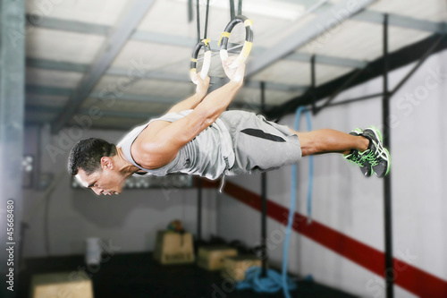 Photo: The sportsman the guy, carries out difficult exercise, sports gy The sportsman the guy, carries out difficult exercise, sports gy