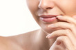 closeup portrait of woman's lips and hand