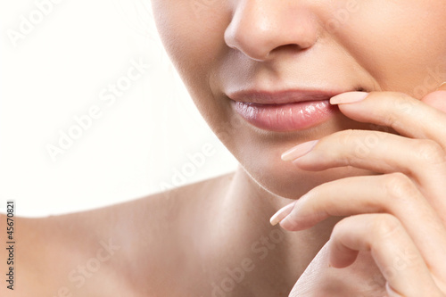 Photo: closeup portrait of woman's lips and hand closeup portrait of woman's lips and hand