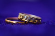 two gold wedding rings on dark background. macro photo