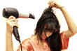 The woman dries hair the hair dryer