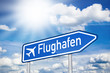 Blaues Schild mit Sonne und Flughafen
