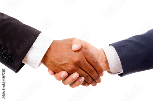 Photo: Handshake between african and a caucasian business man, isolated Handshake between african and a caucasian business man, isolated