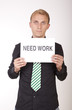 Photo: Young attractive man with a sign need work Young attractive man with a sign need work