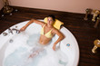 Beautiful young woman relaxing in jacuzzi