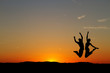 couple jumping in sunset